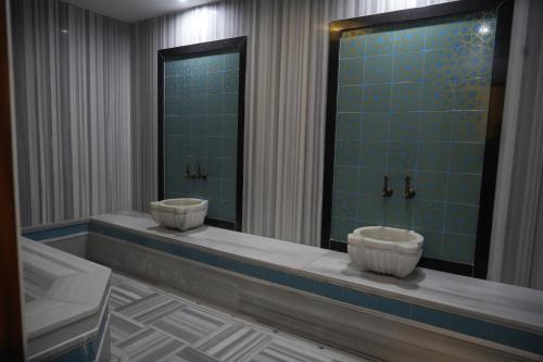 a bathroom with two sinks and a shower at Snowflake Dag Hotel & SPA in Sarıkamıs