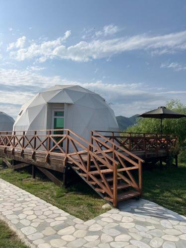a large dome tent sitting on a wooden deck at Chadir yurd glamp in İsmayıllı