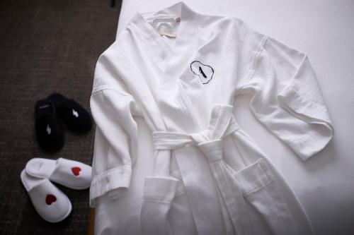 a white shirt with a heart on it next to a remote control at Archer Hotel Tysons in Tysons Corner