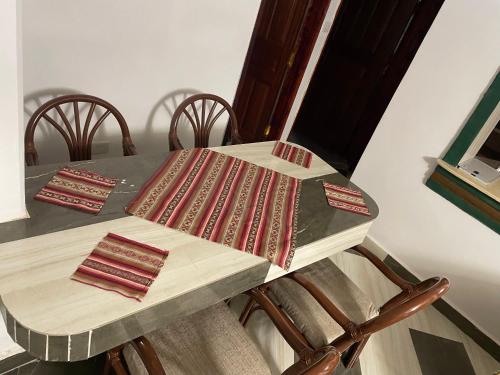 einen Tisch mit Stühlen und einen Tisch mit einem Tischtuch in der Unterkunft New Kitisuru Apartment in Nairobi