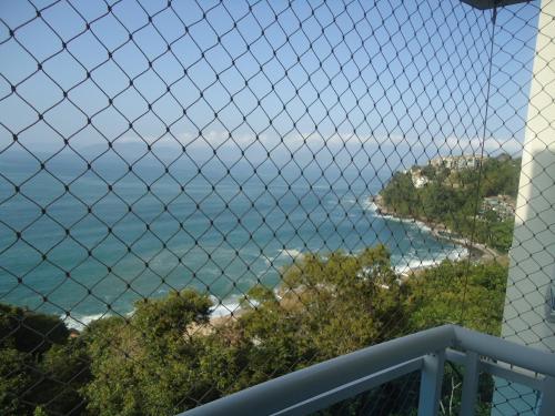 a view of the ocean from a balcony at Apartamento Aconchegante Porto Real Resort Mangaratiba in Mangaratiba