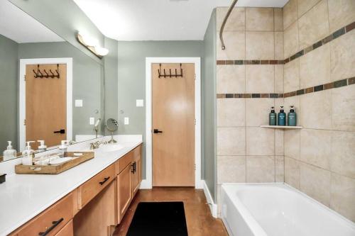 a bathroom with a tub and a sink and a bath tub at 2bd Townhouse with Houston's city skyline view in Houston