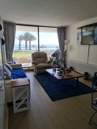 a living room with a couch and a table at San Alfonso del Mar Algarrobo in Valparaíso
