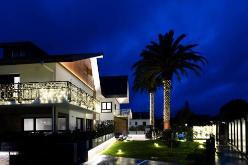 a house with a palm tree in front of it at Arroka in Hondarribia