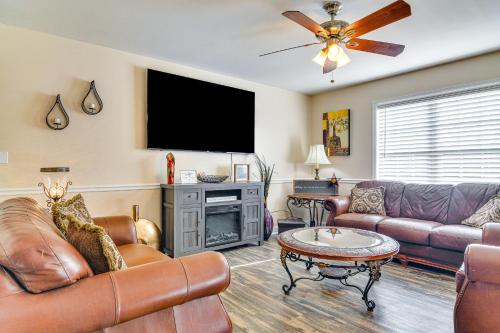 a living room with leather furniture and a flat screen tv at Central High Point Home Less Than 1 Mi to Downtown! in High Point