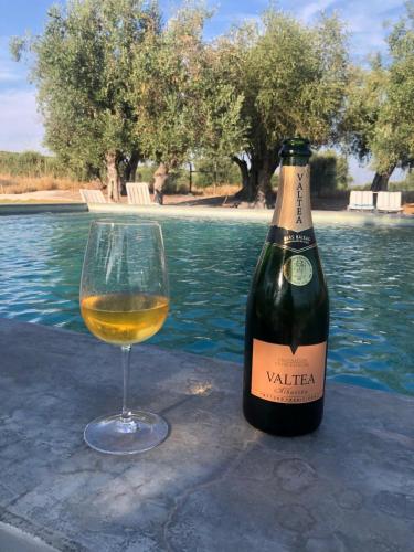 a bottle of wine and a glass on a table at Monte de Santa Maria in Monsaraz