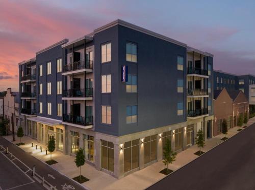 an architectural rendering of an apartment building at dusk at Hampton Inn New Orleans French Quarter Market Area in New Orleans