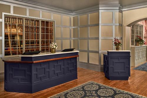 a bar in a wine tasting room with a wall of wine bottles at Carnegie House in State College