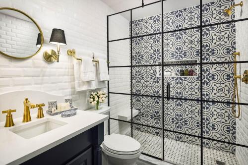 a bathroom with a shower with a toilet and a sink at Carnegie House in State College