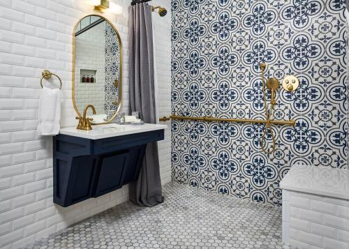 a bathroom with a sink and a mirror and a shower at Carnegie House in State College