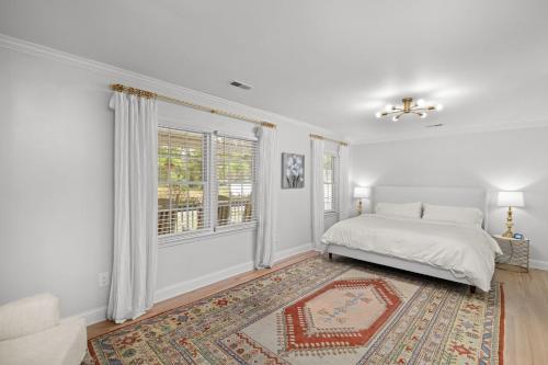 a white bedroom with a bed and a window at Imperial Porch Haven Cozy Fire Pit Fenced Yard in Imperial