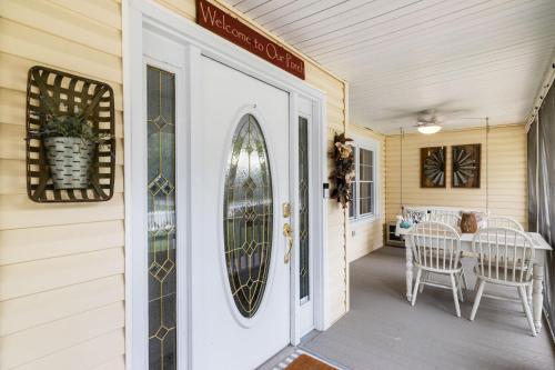 a door to a porch with a surfboard on it at Imperial Porch Haven Cozy Fire Pit Fenced Yard in Imperial