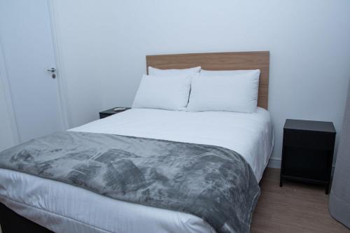 a bedroom with a large bed with white sheets at ST Studios Vila Mariana by Housi in Sao Paulo