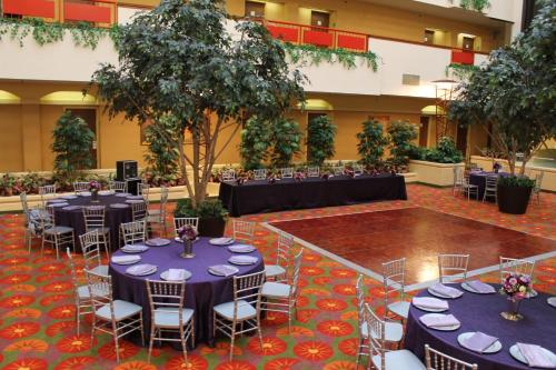 a banquet hall with blue tables and chairs and trees at Holiday Inn & Suites Springfield-I-44 by IHG in Springfield