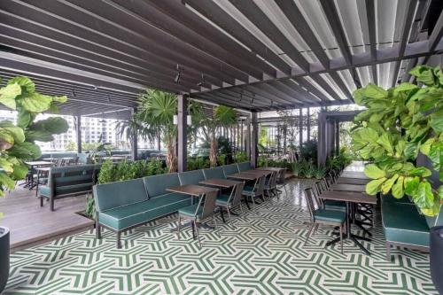 a patio with tables and chairs and plants at Miami Luxe Escape Best High Waterfront Views, City Lights, Pool, Spa Amazing location in Miami