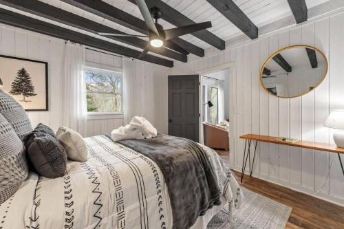 a bedroom with a bed and a ceiling fan at NEW Toccoa River Front - HotTub Fire pit Game Room in Mineral Bluff