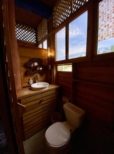 a bathroom with a toilet and a sink at Casa Madre Selva in Brisas de Zicatela