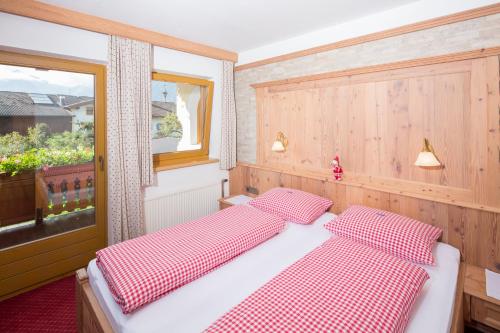 a bedroom with two beds and a window at Landhaus Greil in Reith im Alpbachtal