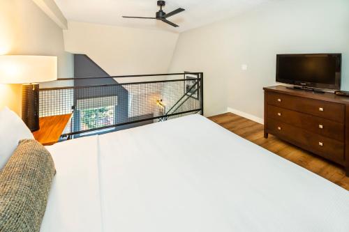 a bedroom with a bed and a flat screen tv at Banff Inn in Banff