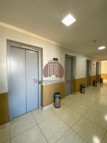 an empty lobby with a sign in a building at Piazza com acesso ao Acqua Park - Temporada CN Adriele in Caldas Novas