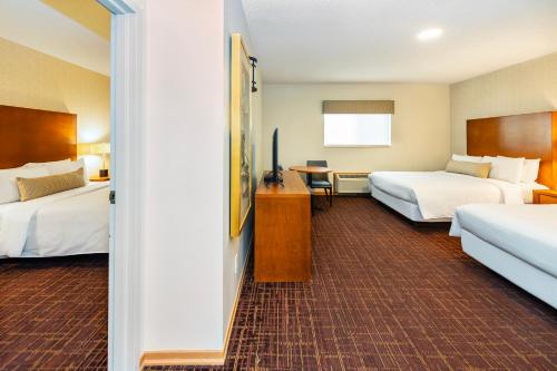 a hotel room with two beds and a table at Banff Inn in Banff