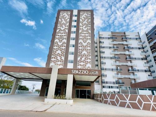 a tall building with a sign in front of it at Spazzio com acesso ao Acqua Park - Temporada CN Adriele in Caldas Novas