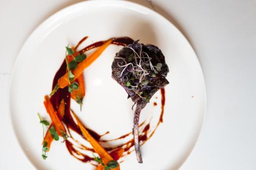 a plate of food with carrots and sauce at Carnegie House in State College