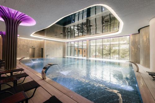 a large indoor swimming pool in a building at Hotel Ivascu in Moisei