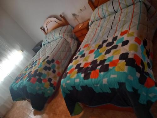two beds sitting next to each other in a room at Villa Trini in Salobreña