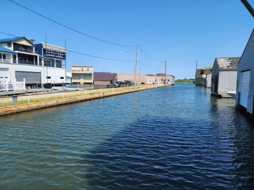 a canal of water with buildings on the side at Sandusky Boathouse with view of Cedar Point in Sandusky
