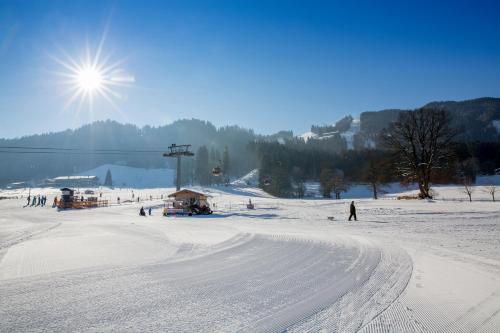 a group of people skiing on a snow covered slope at Landhaus Greil in Reith im Alpbachtal
