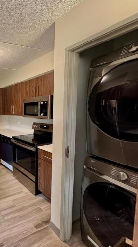 a kitchen with a microwave and a stove at Sleep Inn Oakbrook Terrace - Chicago in Oakbrook Terrace