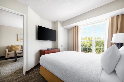 a hotel room with a bed and a large window at Homewood Suites by Hilton Dallas-DFW Airport N-Grapevine in Grapevine