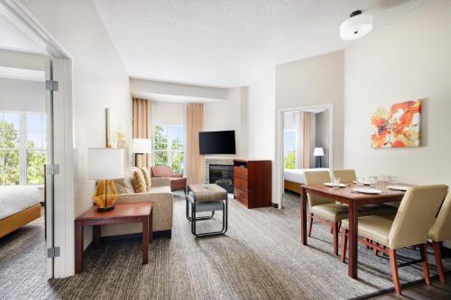 a hotel room with a living area with a dining room at Homewood Suites by Hilton Dallas-DFW Airport N-Grapevine in Grapevine
