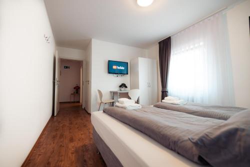 a hotel room with two beds and a window at Three Corners in Grenzach-Wyhlen