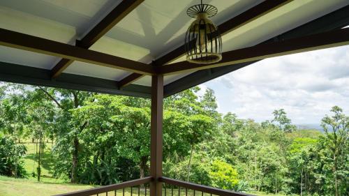 a screened in porch with a view of trees at Divan Eco Lodge in Fortuna