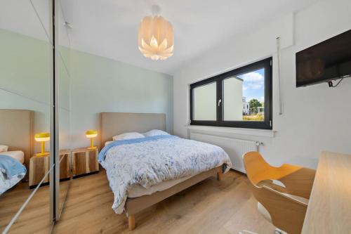 a white bedroom with a bed and a window at Villa66 Private bedroom 3 - Shared Kitchen in Livange
