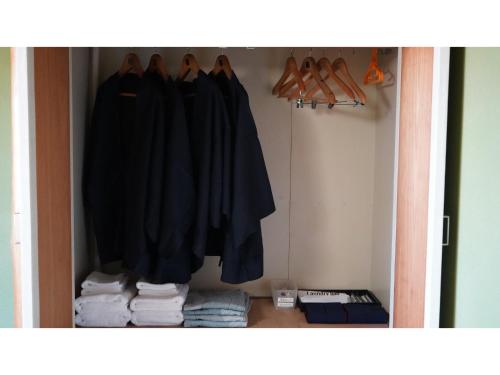 a closet filled with clothes and towels at THE RETREATMENT YUGAWARA - Vacation STAY 86823v in Yoshihama