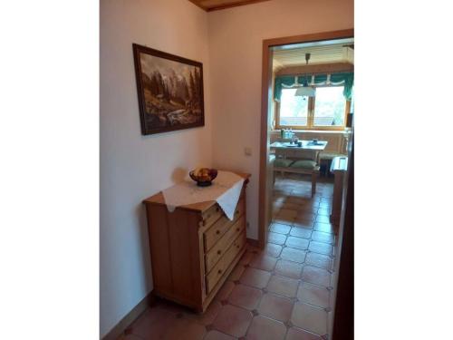 a room with a wooden dresser and a dining room at Holiday apartment Bräu in Riegsee