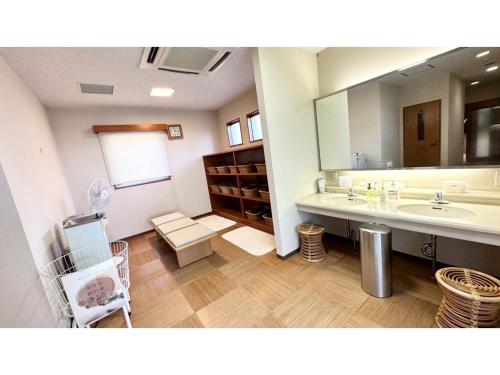 a bathroom with a sink and a large mirror at THE RETREATMENT YUGAWARA - Vacation STAY 86817v in Yoshihama