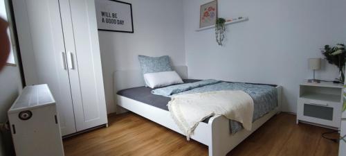 a small bedroom with a bed and a closet at FeWo am Park- mit Ausblick auf den Europa-Park in Rust