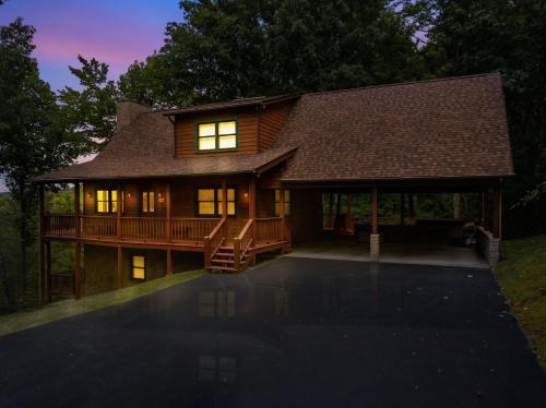 a large house with a wrap around porch at night at Restoration Retreat at Greenbrier cabin in Sevierville