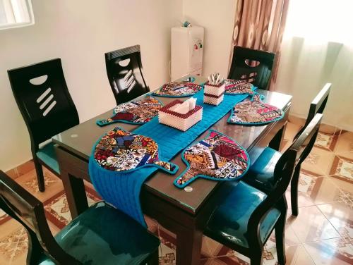 a dining room table with a blue table cloth on it at Havlin's Haven in Kitale