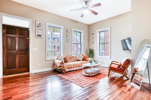 a living room with a couch and a table at Near Starland & River St - Private Patio & BBQ - Parking in Savannah