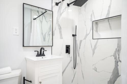 a white bathroom with a shower and a sink at City View Condo with 3 Beds Free Parking LM 07 in Atlanta