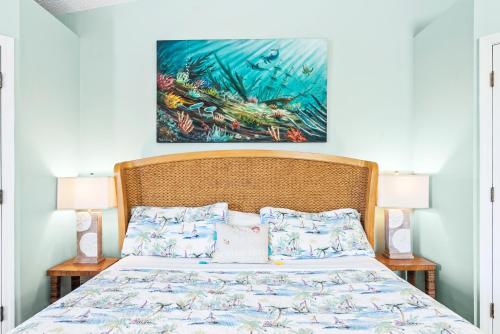 a bedroom with a bed with a painting on the wall at Siesta Key Village, Heated Pool, Beach Access 4 min Walk, 3bdr in Siesta Key