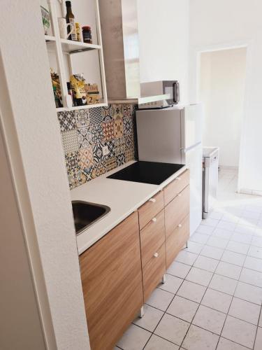 a kitchen with a sink and a refrigerator at Chemnitz - Home Sweet Home in Chemnitz
