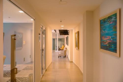 a hallway of a house with paintings on the walls at Holiday Inn Express Merida Centro by IHG in Mérida