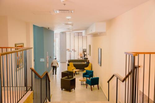 a person walking down a hallway in a building at Holiday Inn Express Merida Centro by IHG in Mérida