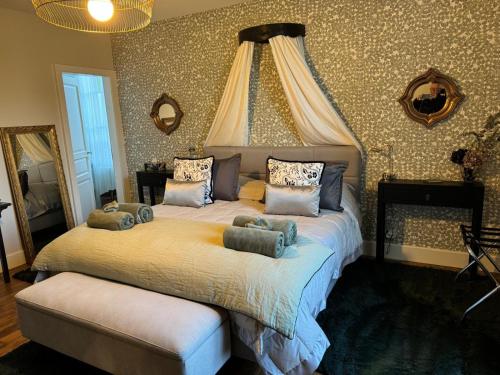 a bedroom with a large bed with pillows on it at Villa Eulalie - Champagne Edouard Duval B&B Guest House nestled in the Champagne area in Bligny